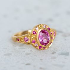 A fine grade pink sapphire has been set into our Roman Ring and is surrounded by shades of smaller pink and yellow sapphires. Centre sapphire measures 7 x 5mm and weighs 0.90ct approx. Band width 2.4mm at the back. Metal weight 6g approx. Pictured here with a matte finish. For a high shine finish please leave a note at checkout. Roman Ring, Pink And Yellow, Instagram Icons, Shades Of Pink, Yellow Sapphire, Pink Sapphire, Earings Piercings, Piercings, Sapphire