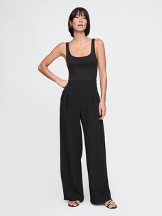 Soft, stretch knit mixed media jumpsuit.  Sleeveless.  Scoop neck at ribbed bodice.  Side slant pockets.  Pleated details at pant.  This jumpsuit's pant is made with 95% recycled polyester.  Compared to virgin materials, using recycled materials helps to reduce resource use and waste.  Fit: Slim.  An A-line silhouette that sits close to the body with a flared opening.  Models wearing Gap All Black Everything, Jumpsuit Black, Black Jumpsuit, Recycled Materials, Autumn Winter Fashion, All Black, Pant Jumpsuit, Bodice, Winter Fashion