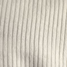 close up view of white fabric textured on the surface with no pattern or color