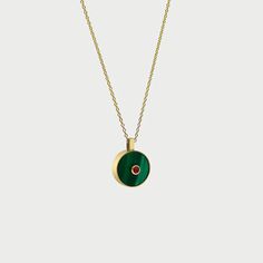 With its rich, vibrant combination of Malachite green and Ruby red, the Necklace N.3 says transformation and abundance in a beautiful way. It is carefully crafted in 14K yellow gold by our master jewelers. 14K yellow gold, Malachite and round Ruby pendant.18" long rolo chain with a loop at 18" and 16".Pendant dimensions: 19.7 mm L, 14.7 mm W, 2.4 mm H.Carat total weight: 0.13 carats. Please note that all pieces are unique. The weight, size and carat weight of each piece can vary slightly from on Luxury Malachite Jewelry, Luxury Round Malachite Jewelry, Luxury Green Round Jewelry, Luxury Malachite Necklaces For Gifts, Green Amulet Pendant Necklace, Luxury Green Emerald Necklaces, Luxury Green Jewelry With Polished Finish, Green Gemstone Round Pendant Necklace, Green Gemstone Necklace With Round Pendant