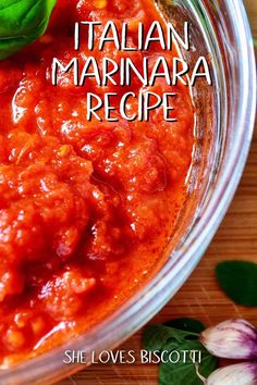 the recipe for italian marinara is in a glass bowl with basil leaves on top