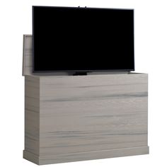 a flat screen tv sitting on top of a wooden cabinet next to a white wall