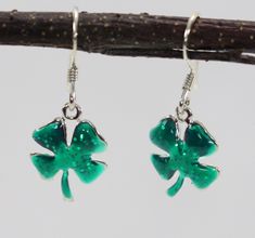 "Sterling silver four leaf clover, shamrock dangle earrings are hand painted with shimmering green epoxy. The earrings are finished with sterling silver French wires.  Add a bit of luck to your day! The shamrocks measure 1/2\" in diameter.  The earrings weigh approximately 2.2 grams Jessica Rose Jewelry is a small handcrafting jewelry company in New Jersey.  We design popular motifs in sterling silver and then add a bit of color to give the jewelry a unique personality. SKU 158" Hypoallergenic Green Enamel Jewelry, Green Dangle Earrings Cadmium-free, Green Cadmium-free Dangle Earrings, Jessica Rose, Silver Sparkle, Rose Jewelry, French Wire, Four Leaf, Drop Earring