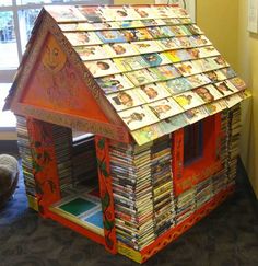 a small house made out of books on the floor