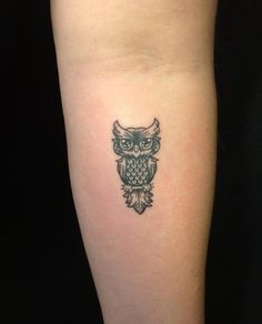 an owl tattoo on the arm