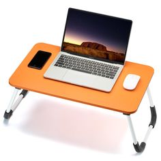 an orange table with a laptop, mouse and cell phone on it that is attached to the side of the table