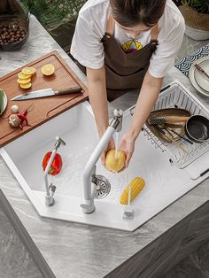 a woman is washing bread in the kitchen sink