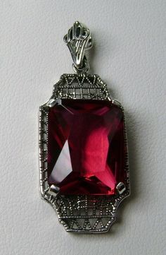 "Simulated Red Ruby Pendant Lantern Design#P13 Custom Made About 6 months ago I found a lovely Art Deco brooch and fell in love with the design. Fashioned in the design of the brooch, I now offer this lovely Antique reproduction pendant in sterling silver (matching 18ct earrings also available for sale). The flawless Simulated 9ct red/pink ruby is 15mm long (just over 9/16\") and 12mm in width (1/2th\"). The pendant is 1 3/8th inches long, it is 9/16th\" wide. The bail opening is 3.5mm wide and Classic Red Gemstone Jewelry, Classic Red Ruby Jewelry, Classic Red Hallmarked Necklace, Classic Evening Ruby Jewelry, Classic Red Birthstone Jewelry, Classic Ruby Necklaces For Formal Occasions, Classic Red Jewelry As A Gift, Classic Red Pendant Necklace, Vintage Ruby Evening Jewelry