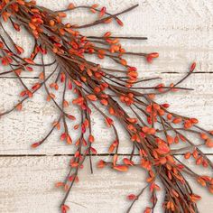 some red flowers are hanging on a white wooden wall and there is no image here