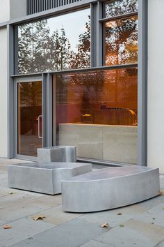 a concrete bench sitting in front of a window