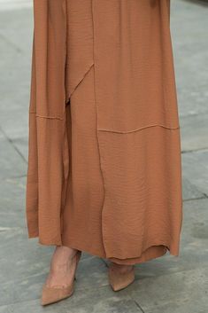 Introducing the Deluna three piece maxi lightweight abaya in rustic brown. This elegant and versatile design is perfect for any season and includes a long sleeve slip dress, apron piece, and a throw over abaya. The fabric is specially designed to resist wrinkles and the contrast brown color overlook seam at the edge of the abaya stands out.The abaya is super lightweight and flowy making it perfect for hot weather. The apron piece allows you to adjust the fit and the pattern of the abaya is not o Fall Season Modest Maxi Length Abaya, Modest Maxi Length Abaya For Fall, Fall Modest Maxi Length Abaya, Brown Full-length Maxi Skirt For Fall, Brown Full Length Maxi Skirt For Fall, Fall Full Length Brown Maxi Skirt, Elegant Brown Full-length Maxi Skirt, Elegant Brown Full Length Maxi Skirt, Spring Modest Maxi-length Thobe