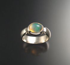 Opal Ring made to order in your size | Etsy Modern Oval Cabochon Opal Ring, Green Oval Opal Ring With Bezel Setting, Modern Oval Opal Ring With Bezel Setting, Modern Opal Ring With Bezel Setting, Modern Green Round Dome Ring, Modern Iridescent Round Ring, Modern Iridescent Round Rings, Masculine Jewelry, Gems Ring