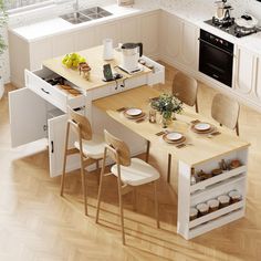 an overhead view of a kitchen and dining room with white cabinets, wood flooring