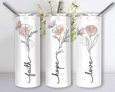 three personalized tumbles with flowers and the word love written on them in cursive writing