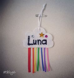 the name luna is written on a cloud with rainbows and stars