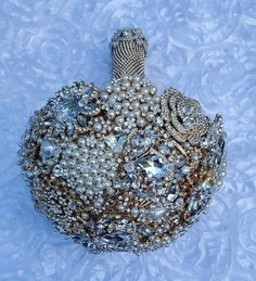 a handbag made out of pearls and other jeweled objects on a blue background