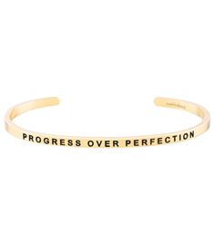 The Mantraband Progress Over Perfection Bracelet is an understated, everyday accessory with an engraved intention. It's a go-to gift, thanks to the gift-ready recyclable packaging with an inspirational message, specific to the mantra. Features "Progress Over Perfection"-engraved adjustable bracelet  Nickel and lead free Stainless steel, dipped in 18K gold Gift-ready, recyclable packaging Details Color: Yellow Gold Adjustable: Yes Materials: 18K gold dipped over stainless steel; lead free and nickel free Care: To clean, wipe items with a soft cloth. Avoid frequent contact with strong chemicals, such as detergent, bleach, perfume, etc. Store in a jewelry box or soft cloth. Always remember to remove your gold jewelry before shower or exercise. Do not wear items in hot tubs or swimming pools. Progress Over Perfection, Mantra Bands, Recyclable Packaging, Gold Gift, Hot Tubs, Everyday Accessories, Gold Dipped, Inspirational Message, Always Remember