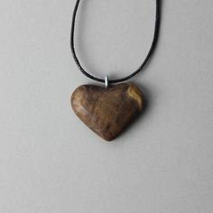 "Your wooden heart pendant has been meticulously hand carved and designed out of precious burl wood. Celebrate 5 loving years of love and joy with this one of a kind wooden hearth shaped necklace. Wood is the traditional 5th anniversary gift. D E T A I L S * This pendant is ready to ship * Handcarved from burl wood * Choose your necklace style and length * Shipped in a beautiful box for easy gift giving * Gift message available upon request (leave in notes) P E N D A N T ∙ S I Z E * 1.5\" / 38 m Engraved Natural Wood Necklace As Gift, Engraved Natural Wood Necklace For Gift, Wooden Pendant Necklace For Gift, Handmade Mahogany Necklace For Gift, Brown Wooden Necklace Gift, Heart-shaped Brown Necklace For Gift, Brown Wooden Necklace For Gift, Brown Wooden Necklace For Gifts, Brown Wooden Necklace Perfect For Gifts