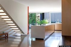 an open kitchen and stairs in a modern home