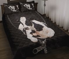 a black and white bed with a panda bear on it's cover is next to a pair of scissors