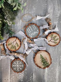 christmas ornaments made out of tree slices with the words let it snow written on them