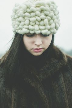 a woman in a fur coat with a hat on her head