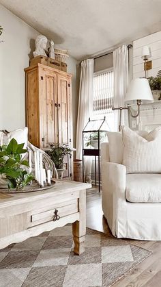 a living room filled with furniture and plants