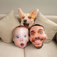 three pillows with faces of two men and a dog on them, one is smiling at the camera