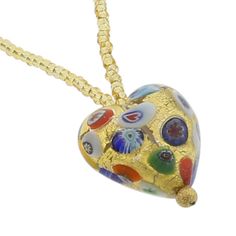 Every woman loves to own unique handcrafted jewelry. This Murano necklace in rich gold and millefiori palette is every woman's dream, rich and beautiful like Venice itself. The authentic Murano necklace features an exquisite 24K gold-layered heart pendant suspended from an elegant gold-lined beaded necklace accented with gorgeous 24K gold-lined and millefiori Murano glass beads. Enjoy this unique Murano Necklace and the aura of Venetian romance and elegance that it projects. Measurements: The he Murano Glass Pendant Necklace For Gift, Round Murano Glass Gold Jewelry, Multicolor Heart Pendant Necklace For Gift, Elegant Multicolor Heart Beads Necklace, Elegant Multicolor Heart Pendant Necklace, Gold Murano Glass Jewelry For Gifts, Gold Murano Glass Jewelry As Gift, Yellow Murano Glass Jewelry Gift, Gold Heart Beads Pendant Necklace