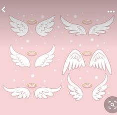 white angel wings and halos on a pink background