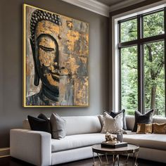 a living room filled with furniture and a large painting hanging on the wall above it