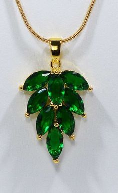 Green Crystal Leaf Charm Necklace ☆ Sparkling GREEN Cubic Zirconium     Leaf  Charm NECKLACE     on a 45cm / 17.7 inches     Gold-plated stainless     steel SNAKE CHAIN 1mm wide     with lobster clasp. ☆ 8 Almond shaped GREEN     CZ stones create this beautiful     charm which measures     20mm tall by 15mm wide. ☆ Eco-Gift Packaging in reusable     gift box and decorative bag. ☆ Arrives Ready for Gifting!  ☆ Ships same day as ordered to USA. ☆ A FREE GIFT is included       with every purchase! Stocking Stuffers For Mom, March Birthday Gifts, Eco Gifts, Almond Shaped, Tree Necklace, Green Crystal, Leaf Charms, Leaf Necklace, Organza Gift Bags