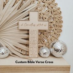 a wooden cross sitting on top of a table next to disco balls