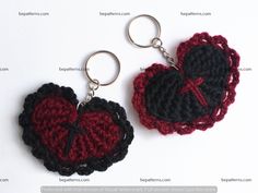 two crocheted heart shaped keychains on a white surface