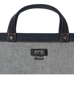 A.P.C. tote bag. - Unisex model. - Two large handles. May be carried by hand or on shoulder. - Exterior pocket embroidered with caramel-colored A.P.C. logo. - Interior pocket. - Rivets engraved A.P.C. - Caramel-colored topstitching. Designer Everyday Bag Medium Size, Designer Medium Bags For Everyday Use, Designer Everyday Medium Bag, Designer Medium Everyday Bag, Large Satchel With Dust Bag For Errands, Designer Canvas Tote Bag With Top Carry Handle, Designer Canvas Tote Bag With Top Handle, Large Satchel With Dust Bag For Daily Use, Top Handle Canvas Bag For Errands