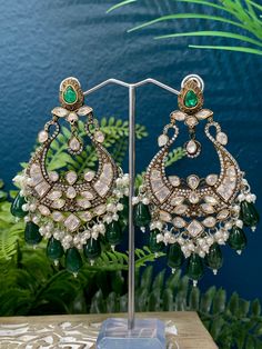 Top quality moissanite kundan jhumki. Medium to over size. 5 inch long and 2 inch wide. Push and clip back, light weight and gold plated. Super suitable for ppl with metal allergies. Pearl drops and lining . Green pota stone. Monalisa stone drops with AD lining all over . Antique polish. Luxury Stone Work Round Danglers, Luxury Meenakari Jhumkas For Women, Luxury Meenakari Jhumkas For Ceremonial Occasions, Jhumki Earrings, Back Light, Over Size, Stone Work, Pearl Drop, Allergies