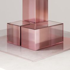 three pink boxes stacked on top of each other