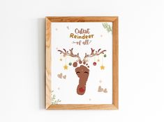 a wooden frame hanging on the wall with a reindeer's head painted on it