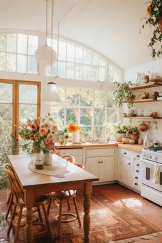 a kitchen filled with lots of counter space and white appliances next to an open window