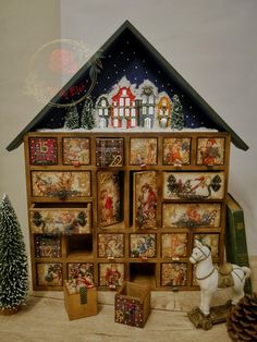 a christmas scene with a doll house and other decorations