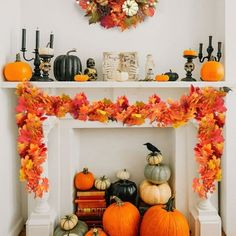 a fireplace decorated for halloween with pumpkins, leaves and other decorations on the mantle