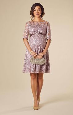 The perfect pregnancy lace party dress in beautifully sheer lilac lace for parties or as a wedding guest. The sleeves sit just below the elbow to give balance to the swishy, fun skirt that follows. A lovely, 1950s inspired shape with a stylish boat neckline and matching satin sash at the waist. -Pretty floral sheer lace -Boat neckline Scalloped Lace Mother Of The Bride Dress For Party, Spring Wedding Boat Neck Dress, Elegant Pink Maternity Dress For Party, Elegant Lace Maternity Wedding Dress, Elegant Maternity Wedding Dress With Lace Trim, Elegant Wedding Maternity Dress With Lace Trim, Pink Lace Dress For Mother Of The Bride, Fitted Lace Maternity Dress For Wedding, Lace Maternity Wedding Dress With Scalloped Lace