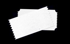 two pieces of white paper on a black background