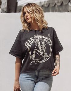 Six Shooter OVERSIZED 90's vibe distressed Cropped T- shirt available in faded black Model is 5ft 4 wearing a size Small This Crop Jersey Tee slides right into streetwear style for Summer and Winter.. With oversized sleeves and a relaxed body, this on-trend tee drops a little lower in the back for an effortlessly cool feel. Fabricated from ultra-soft, lightweight Airlume cotton that's fit to flatter, this looser crop features a finished hem and neck binding.Features: Finished hem. Oversized slee Edgy Faded Distressed T-shirt, Spring Grunge T-shirt For Alternative Fashion, Edgy Distressed Crew Neck T-shirt, Trendy Washed Black T-shirt, Faded T-shirt For Summer Streetwear, Trendy Faded T-shirt For Streetwear, Casual T-shirt With Frayed Hem, Oversized Edgy T-shirt For Fall, Casual Frayed Hem T-shirt For Summer