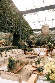 a living room filled with lots of furniture and plants on top of it's walls