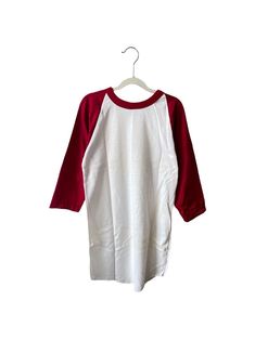 a white and red shirt hanging on a hanger