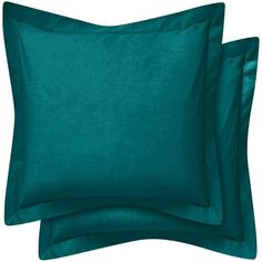 two teal colored pillows on top of each other with one pillow in the middle