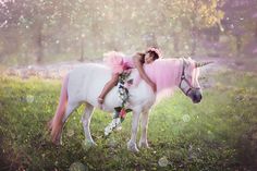 two children are riding on the back of a white horse with pink manes and flowers