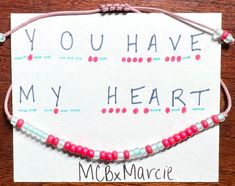 a card that says you have my heart and two bracelets with beads on it