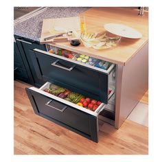 an open drawer in the middle of a kitchen counter with food inside and on it